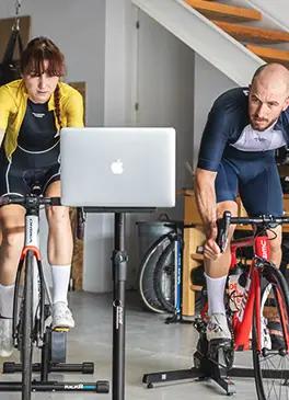 Cyclistes s'entraînant à la maison avec un simulateur de cyclisme en intérieur